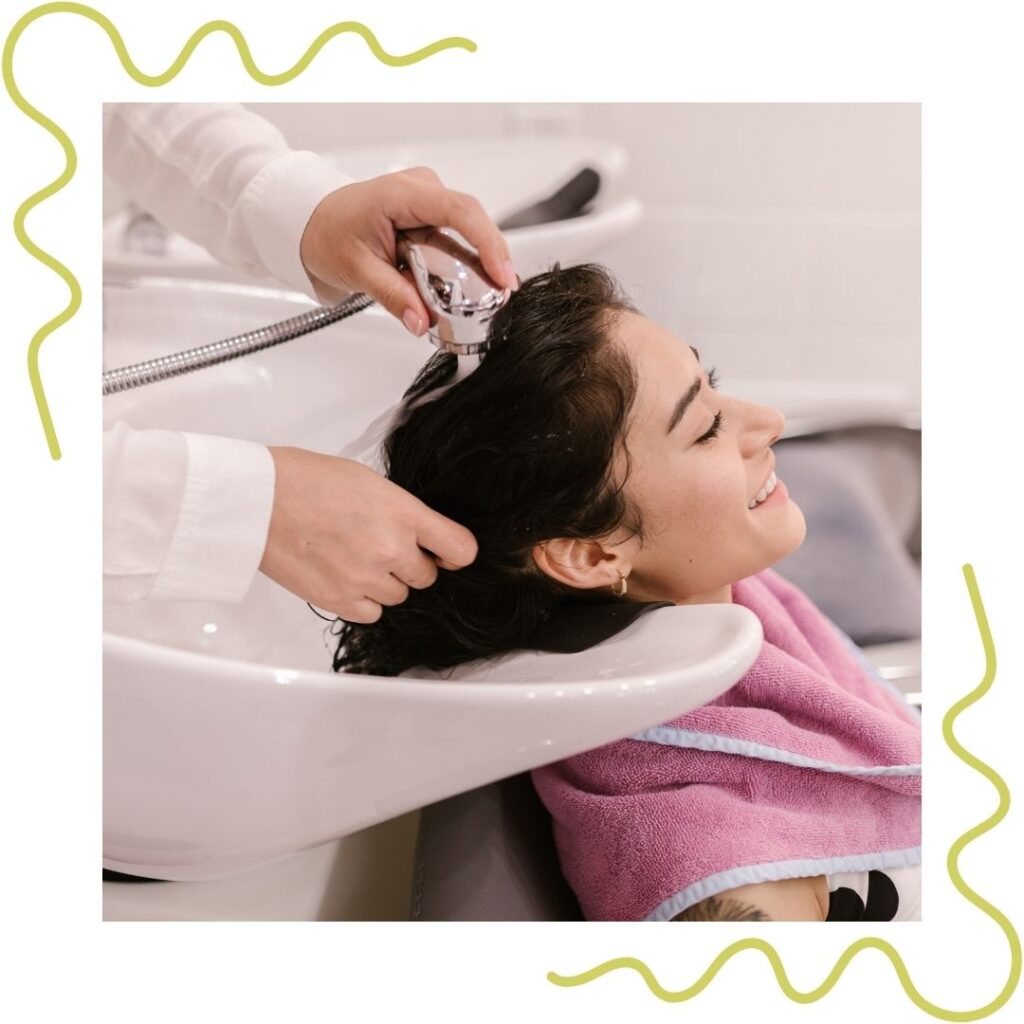 A woman having her hair washed at a salon